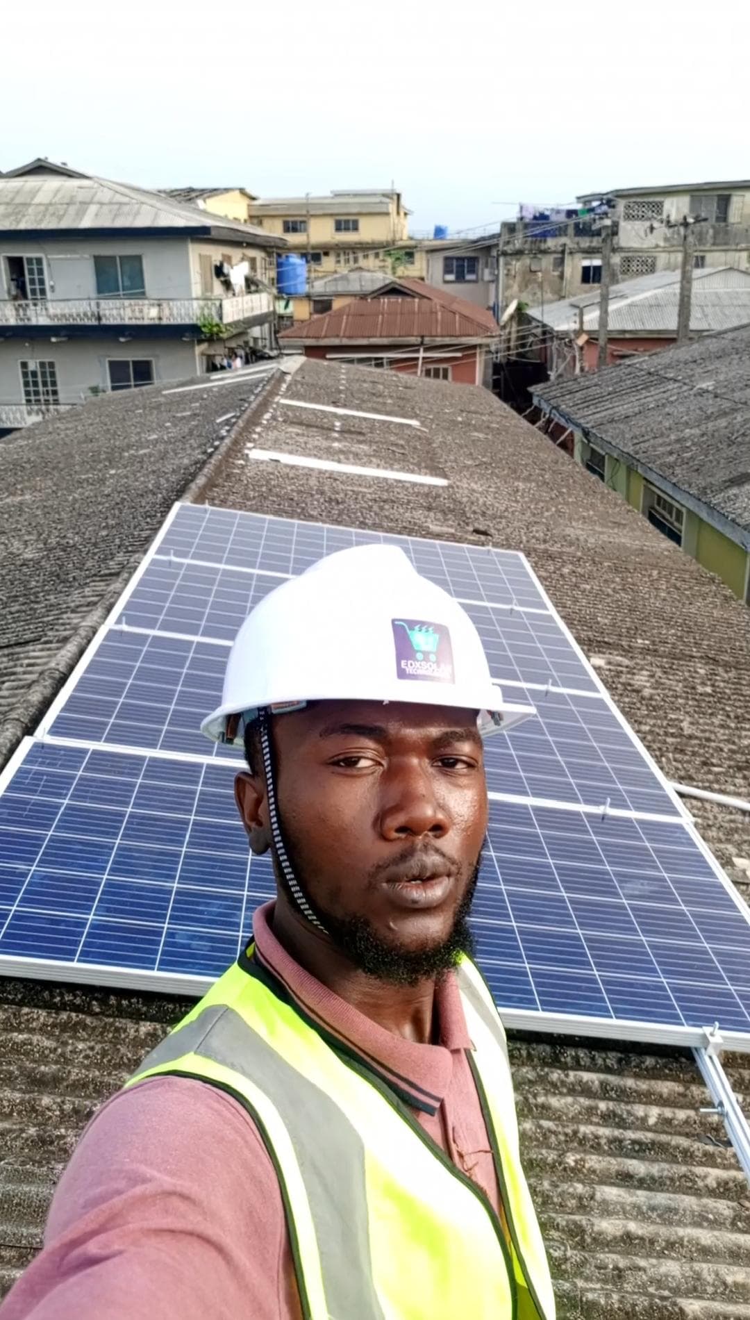 Man smiling in front of a solar installation